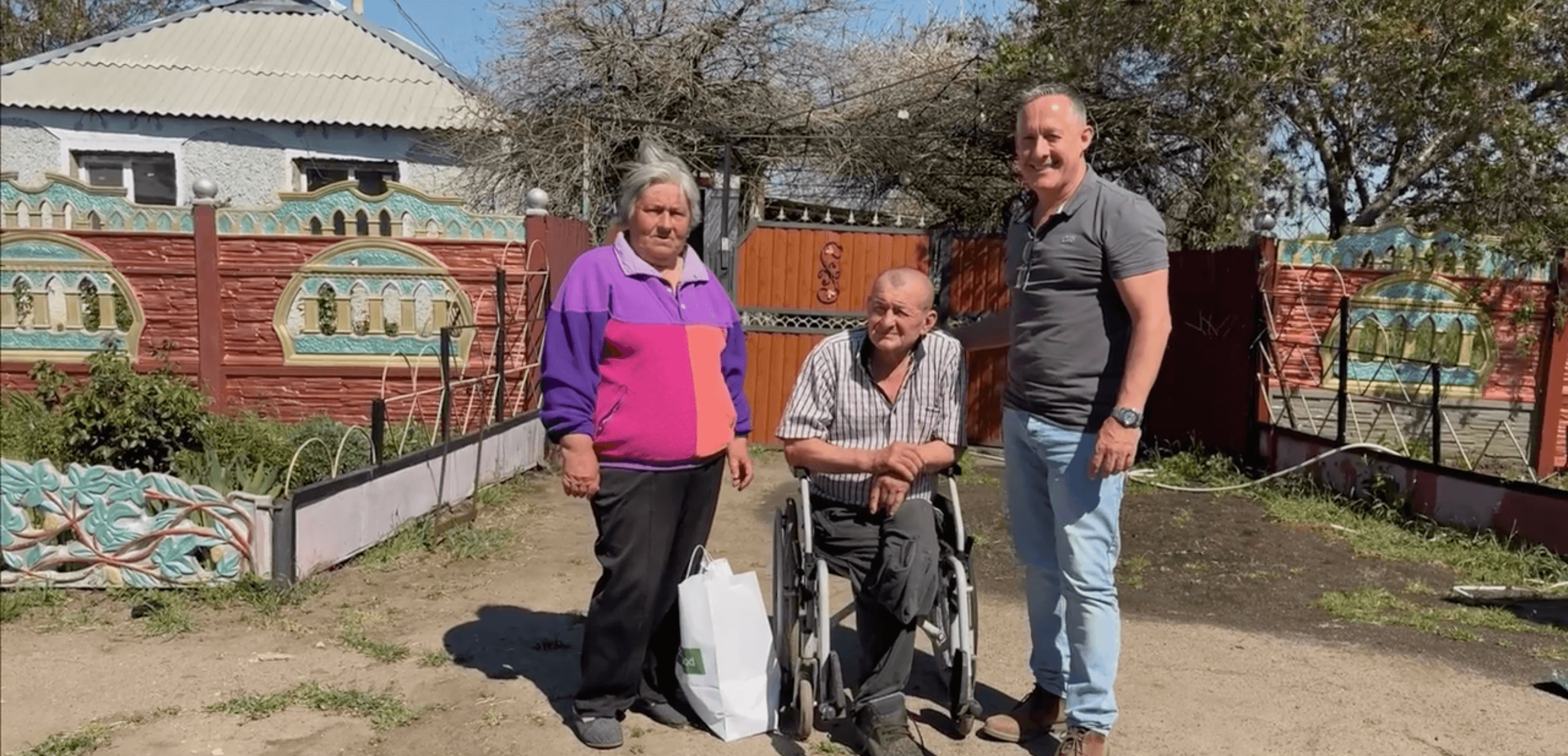 Hope4 team member with community beneficiaries receiving wheelchair assistance
