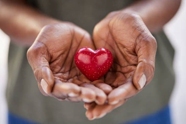 Hands holding a heart symbolizing compassionate healthcare